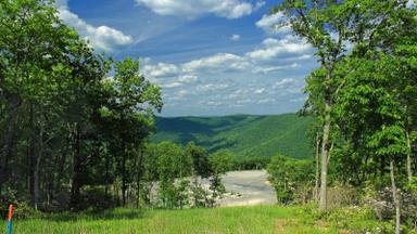 Natural gas well pad in a forest clearing below green Pennsylvania mountains. Photo: Nicholas A. Tonelli via Wikimedia Commons, CC BY 2.0 (cropped)