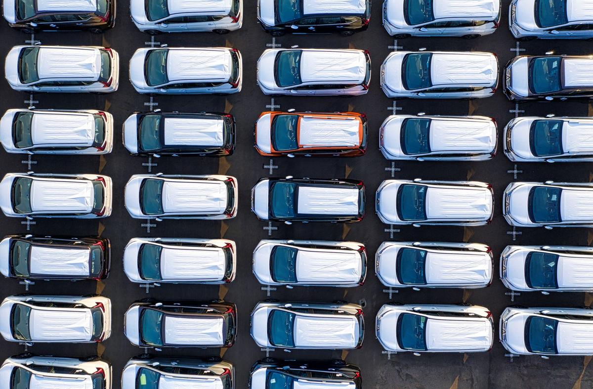 Aerial view of rows of new cars parked in a lot. Photo: Tom Fisk on Pexels
