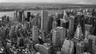 Black and white aerial view of Midtown Manhattan towers looking west toward the Hudson River. Photo: The New York City Skyline at Dusk looking West, Bruce Emmerling / Wikimedia Commons, CC BY-SA 4.0 (cropped and resized)